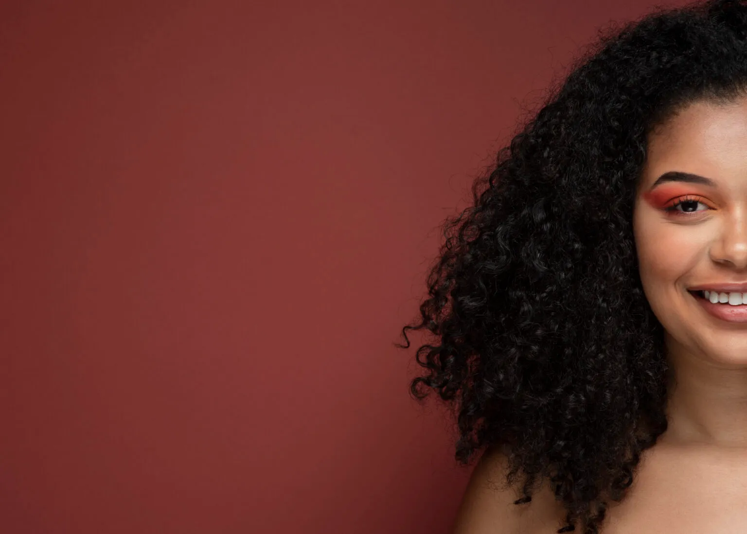 Mulher sorridente com cabelo cacheado